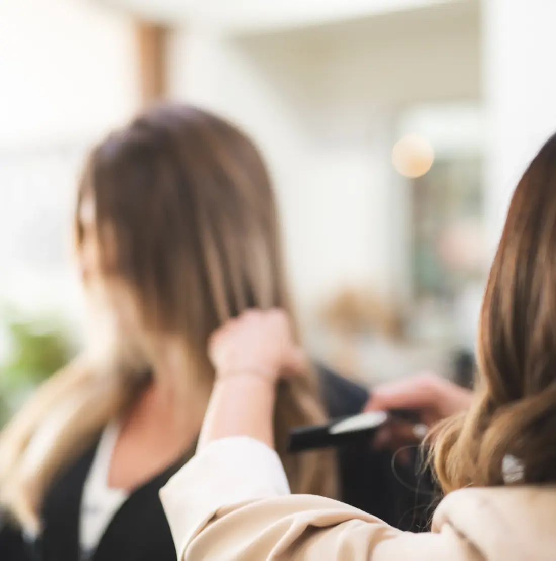 Employee stylist working with a client at Studio One